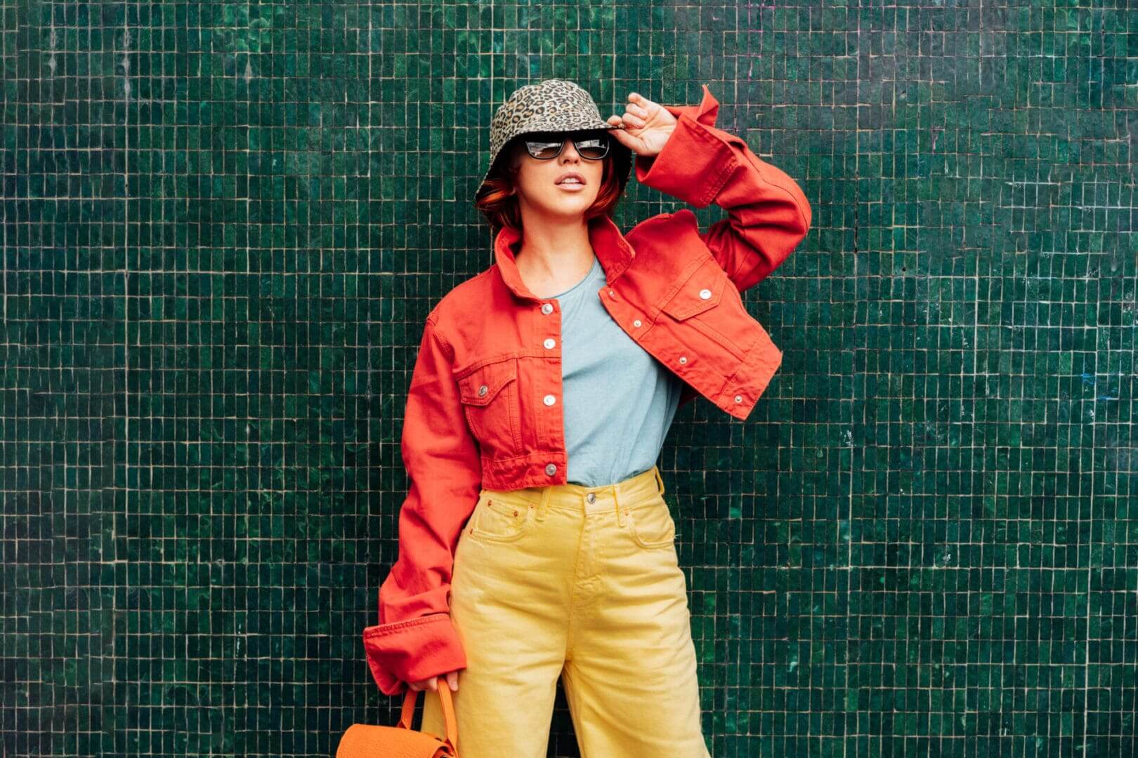 Stylish woman in colorful outfit and hat.