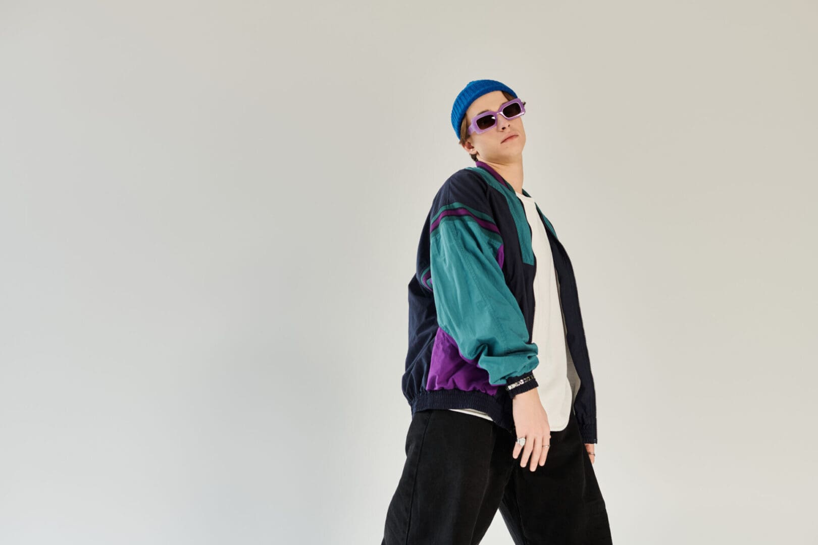 Person in retro outfit and sunglasses posing.