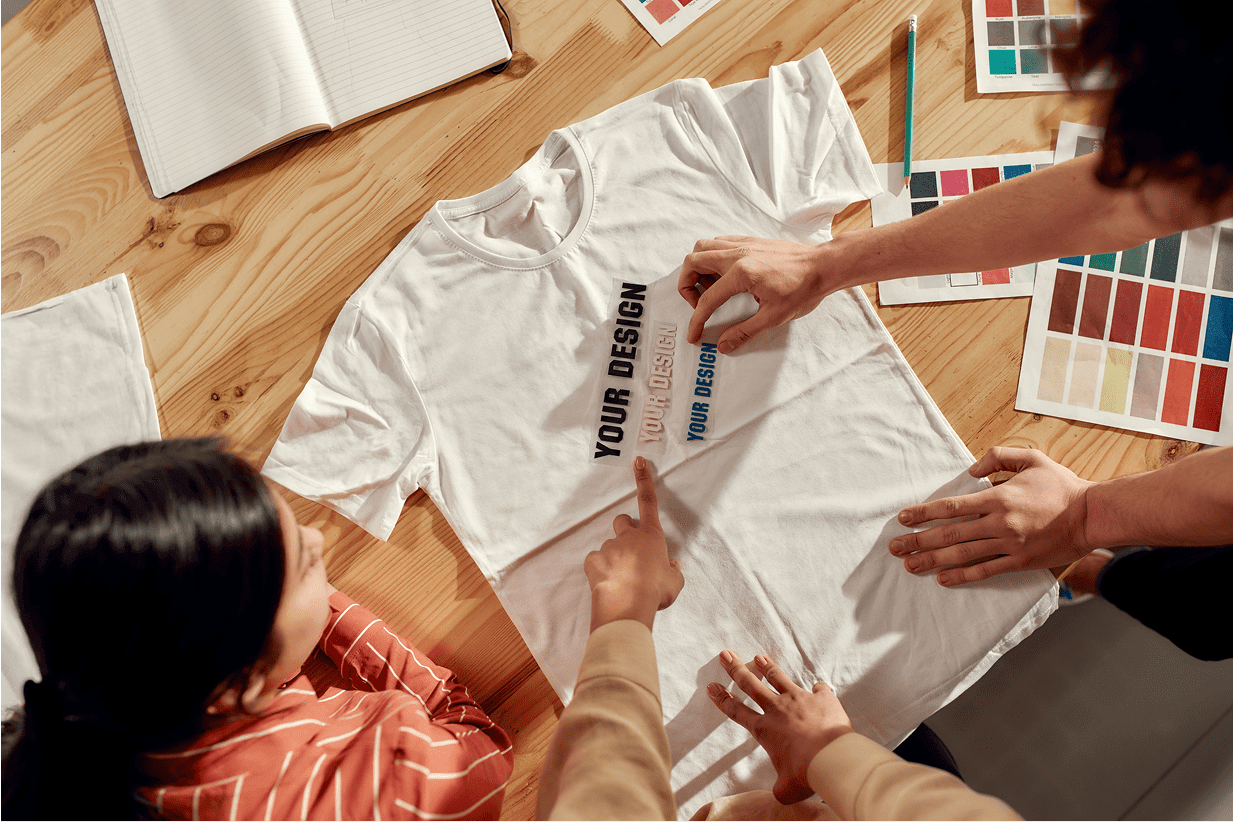 Designers customizing a white T-shirt together.